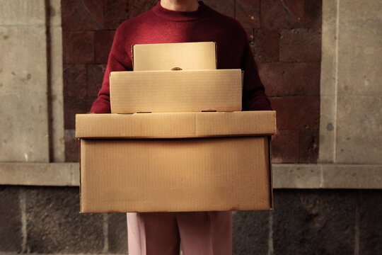 Boxes Held by an Anonymous Man