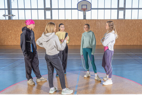 Young amateur sport team receiving instruction from coach