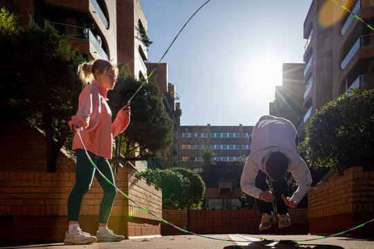 Group of friends having fun doing acrobatic exercises in patio