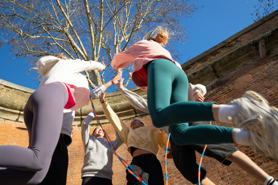 Friends jumping giving Girl Power Hi Five.