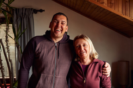 Son embraces his mother and laughs