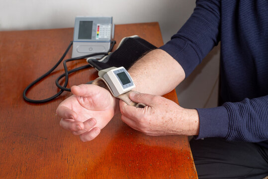 Faceless, Elderly man measures his blood pressure on his own
