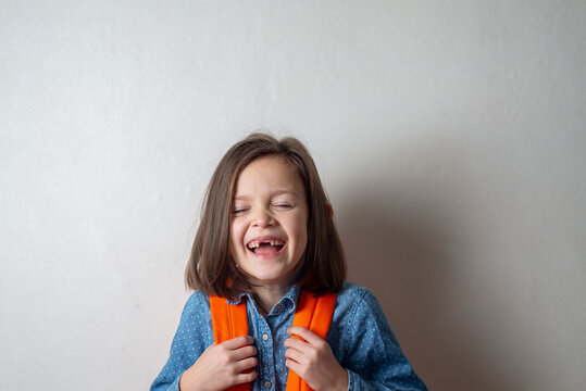 Portrait of a Laughing Girl Child Without Front Teeth