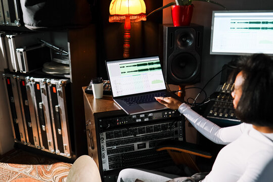 Woman Uses Laptop in Recording Studio