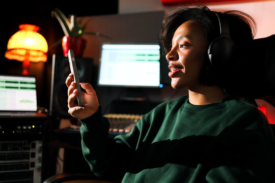 Woman using phone in creative workspace
