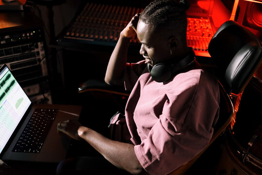 Man Editing Audio Tracks in Studio