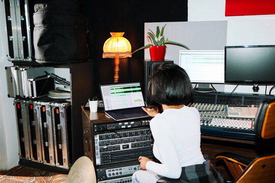 Woman Sound Engineer Working in Studio on Laptop 