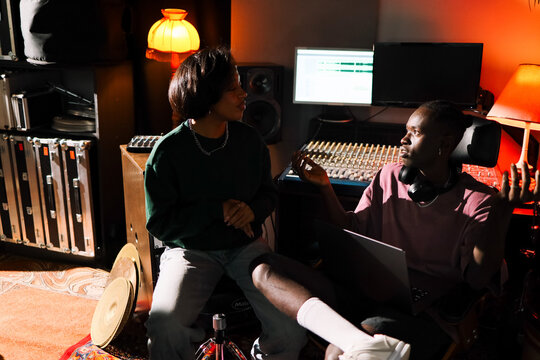 Music Producers Brainstorming in Recording Studio