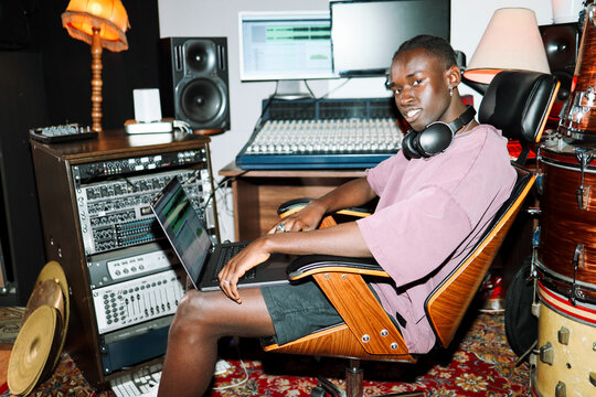 Man Smiling Working  on Laptop Music 
 Studio 