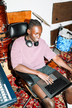 Music Producer Working on Tracks with Laptop