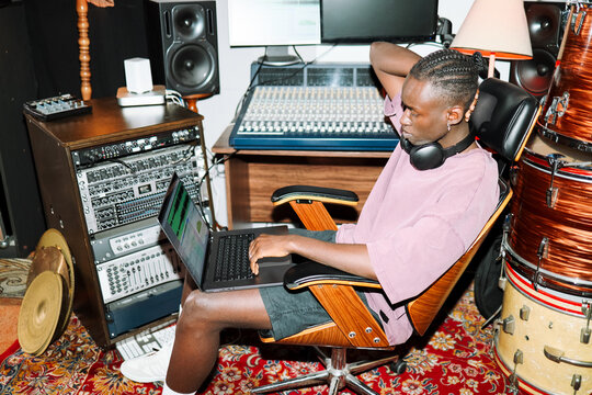 Man Mixing Music on Laptop in  Recording Studio