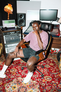 Confident Man Sitting in Music Studio