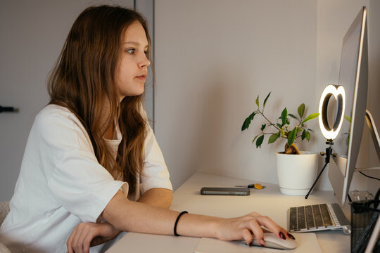 Teenager studying on a computer at home in a cozy environment