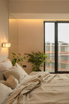 Cozy bedroom with plants and a view of the city skyline