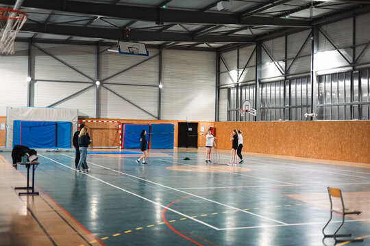 Teenagers grouping in center of basketball court