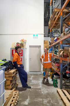 Apprentice taking instruction from supervisor at workplace 