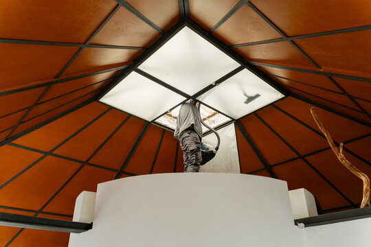 Worker repairing roof ceiling