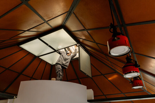 Worker repairing roof ceiling