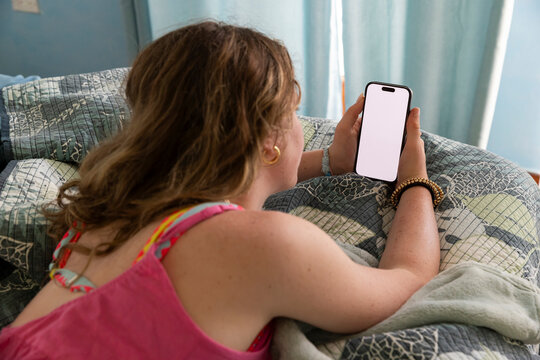 Teen girl cell phone video streaming  in bedroom