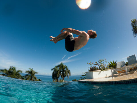 Swimming pool  teenage doing flip jumping 