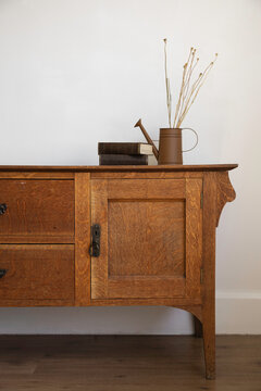 vintage sideboard with books and vase