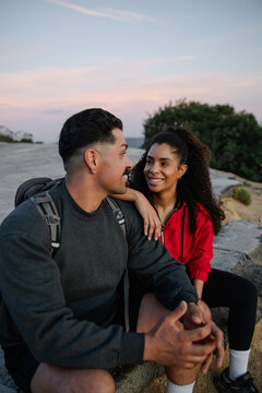 Couple Enjoying Sunset Outdoors, Expressing Connection