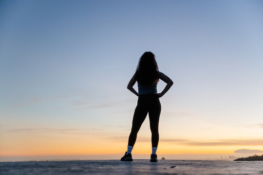 Confident Fitness Woman Posing Against Stunning Sunset Outdoors