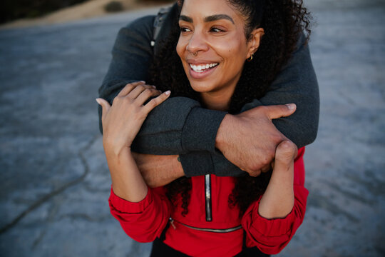 Happy Couple Embracing Outdoors in a Romantic Gesturey