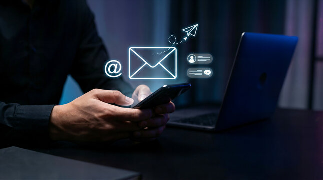 Digital marketer using email marketing tools on laptop and smartphone, sending newsletters and analyzing campaign performance to engage subscribers and grow business through personalized content