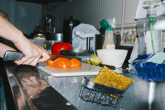 Woman's hands sliding a tomato