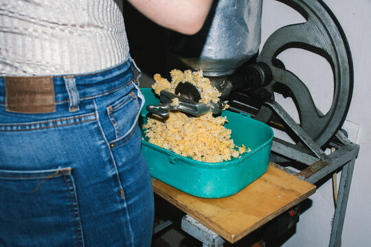 Woman operating corn grinding machine