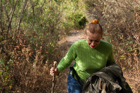 Woman smiling While Navigating Nature's Trail