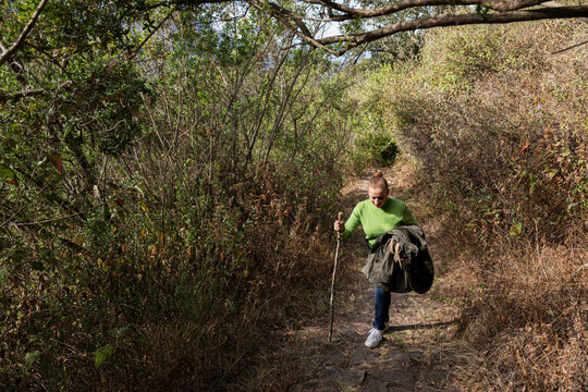 Woman Climbing Up Rocky Path in the Wilderness