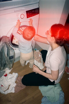 Baby Helping with Mom with Laundry. household chores with kid- film an