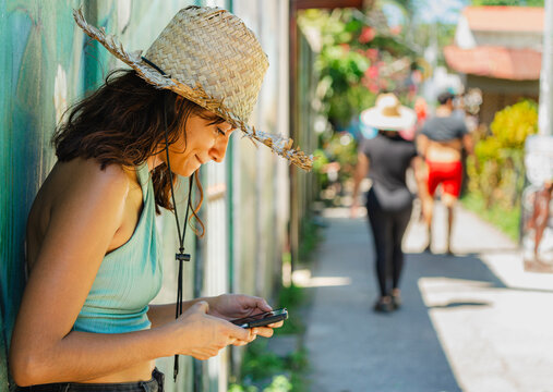 Young woman using cellphone in Tortuguero