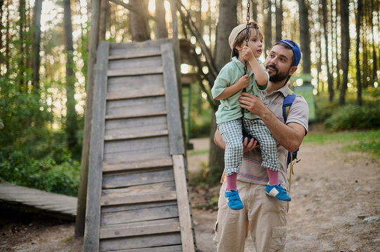 dad teaching his little son ride the children's zipline 