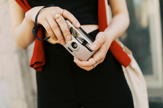 young  woman with point and shoot film camera outdoors