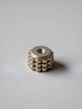 stack of small round ceramic ferrite magnets on textured gray  paper