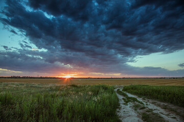 Dramatic Storm Clouds at Sunset over Rural Plains