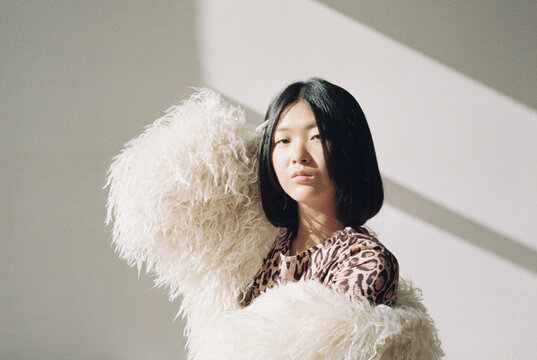 Film photography of stylish young woman in light room