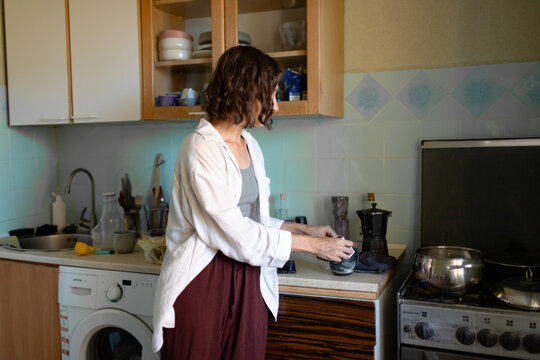 the woman is standing in the kitchen