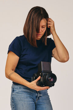Photographer in studio with film camera