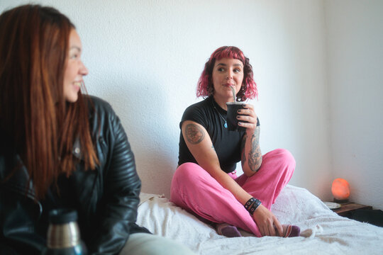 Relaxed Conversation Over Mate in a Cozy Bedroom