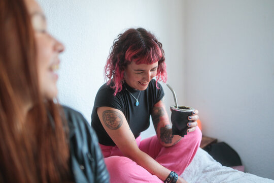 Laughing with a Friend Over Yerba Mate Indoors