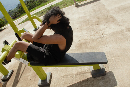 Man doing ab exercises on outdoor gym machine