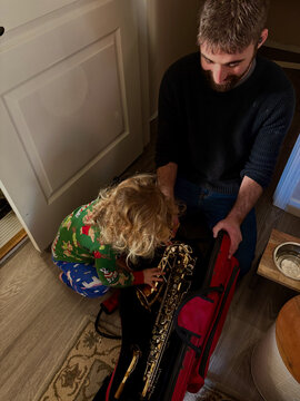 Dad shows daughter saxophone