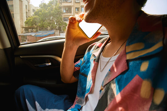 Man talking on the phone inside a car