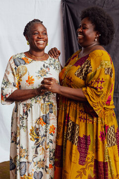 Mother and daughter cheerfully holding hands
