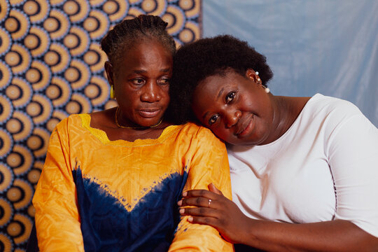 Daughter holding onto mother's arm