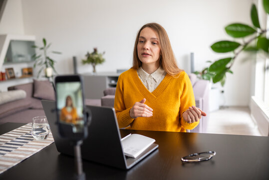 Woman recording a podcast at home